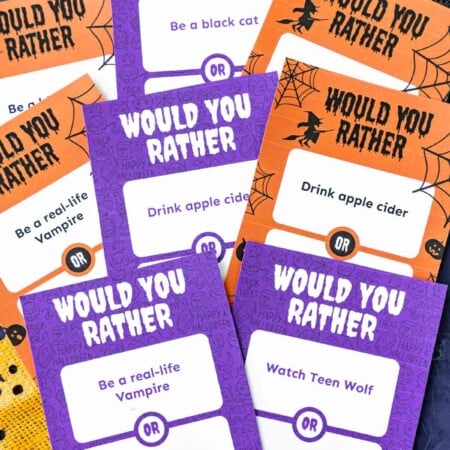 Purple and orange papers with Halloween themed would you rather questions on them