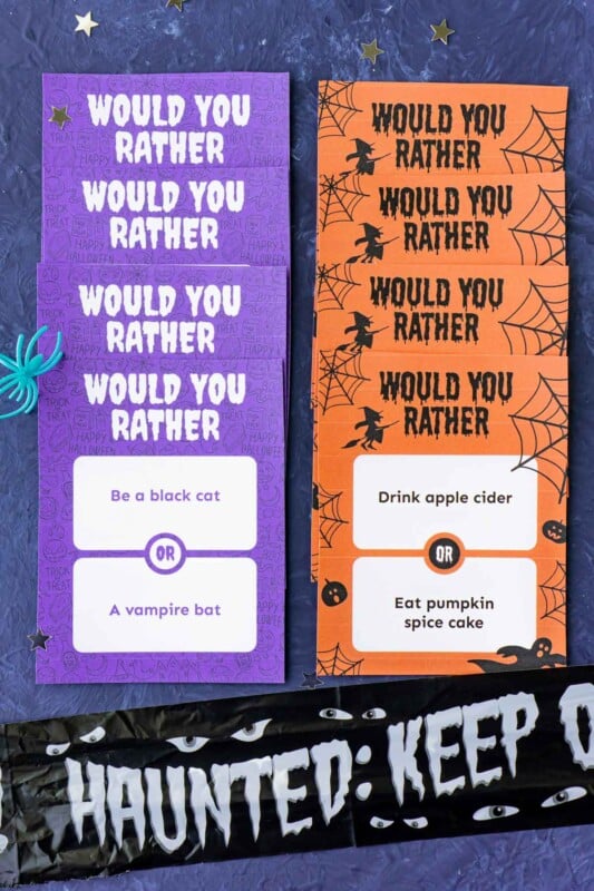 A row of purple Halloween would you rather question cards and a row of orange cards