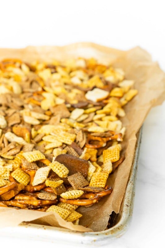 Baking sheet lined with parchment paper and topped with Chex Mix