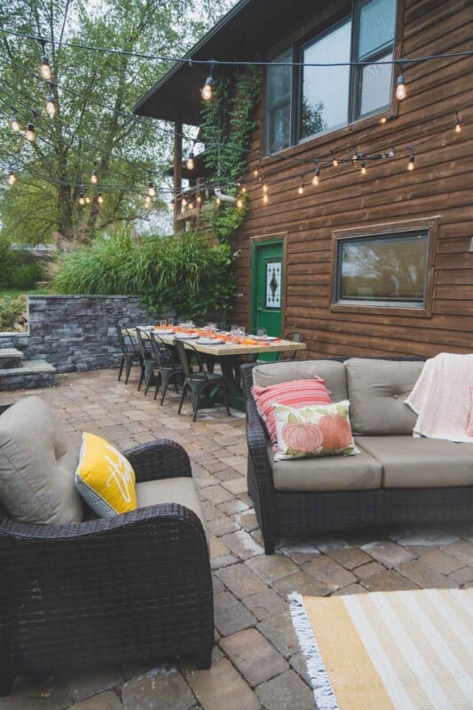 Chairs with fall colored pillows in an outdoor entertaining area