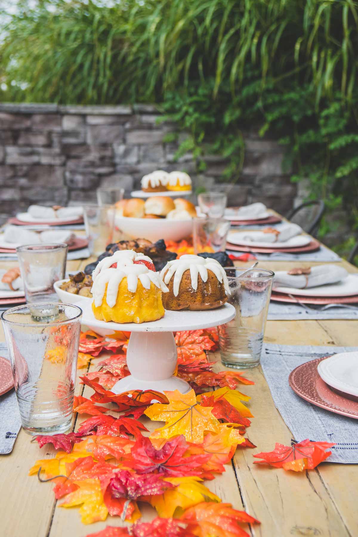 Fall table with fall colored bundt cakes