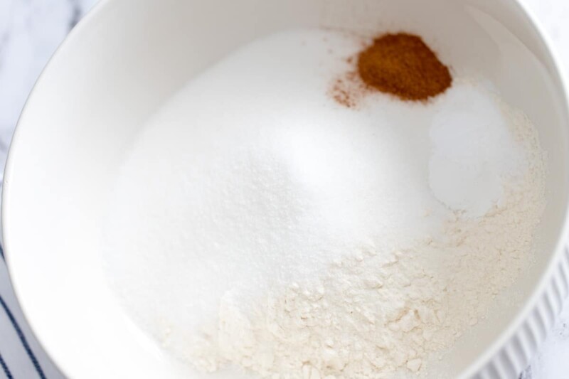 Flour, sugar, and other dry ingredients in a white bowl