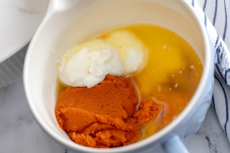 Pumpkin, egg, yogurt, and vanilla in a white bowl