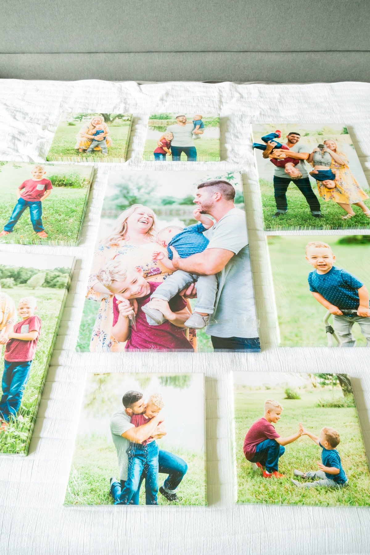 Photo canvases laid out on a bed