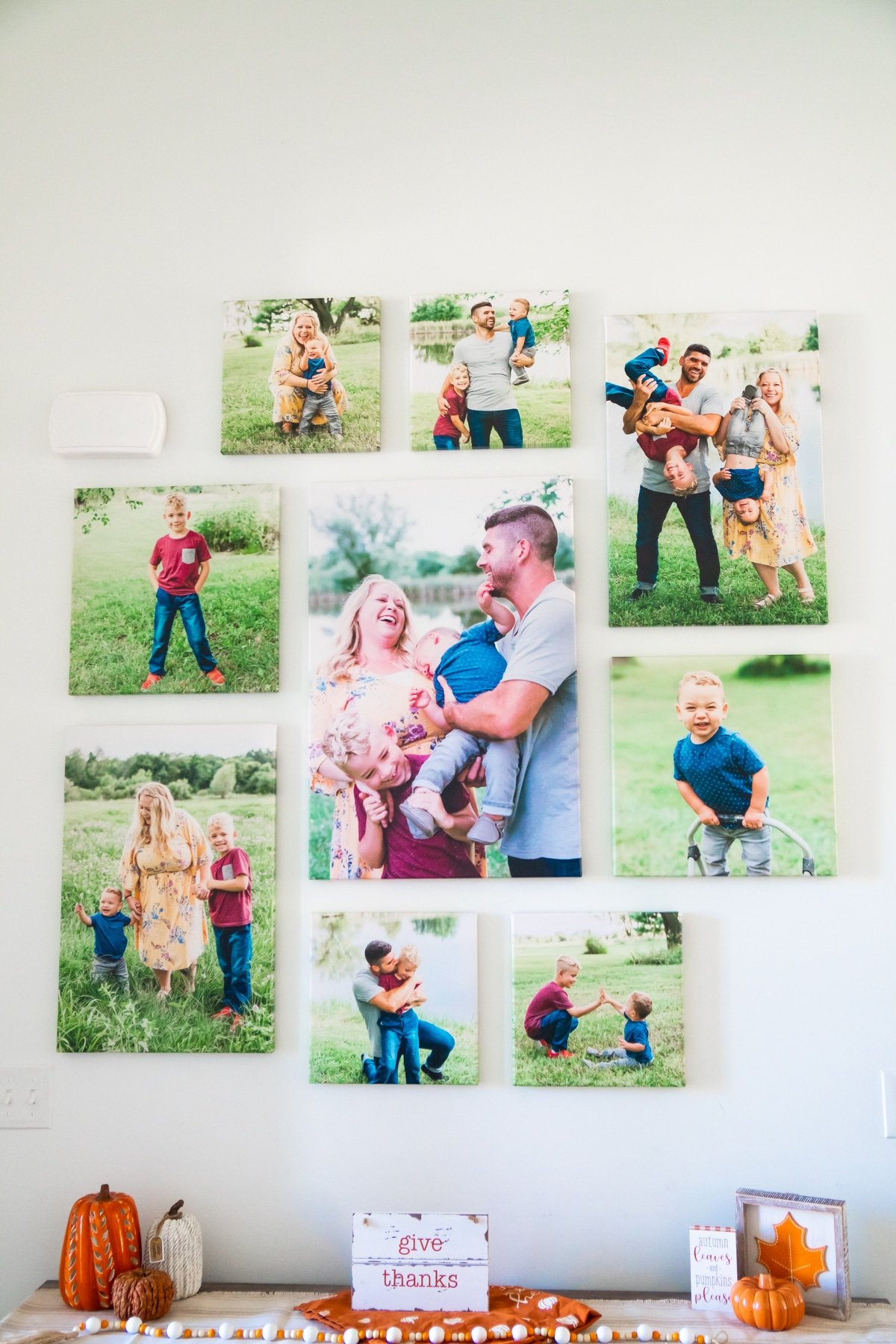 DIY photo wall made with canvases above an entry table