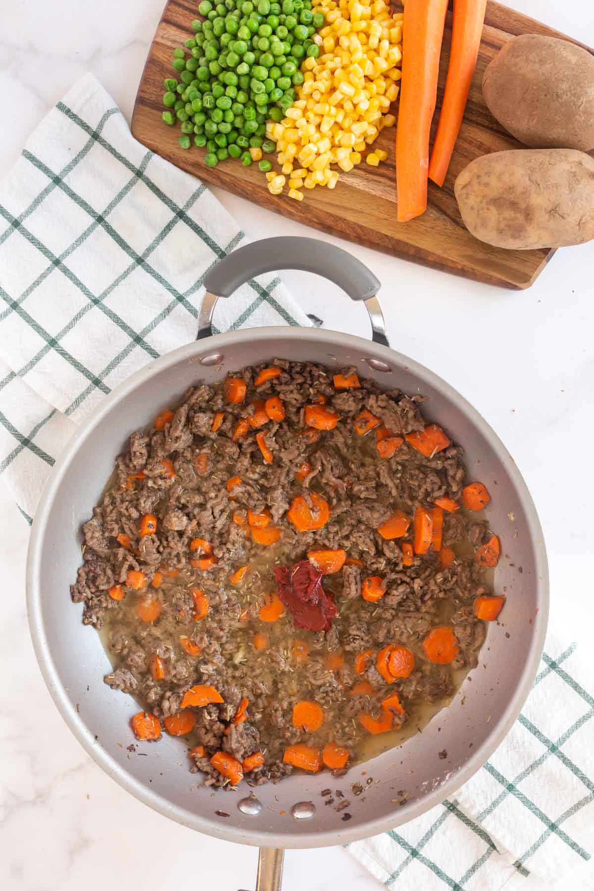 Meat mixture with tomato paste in a metal pan