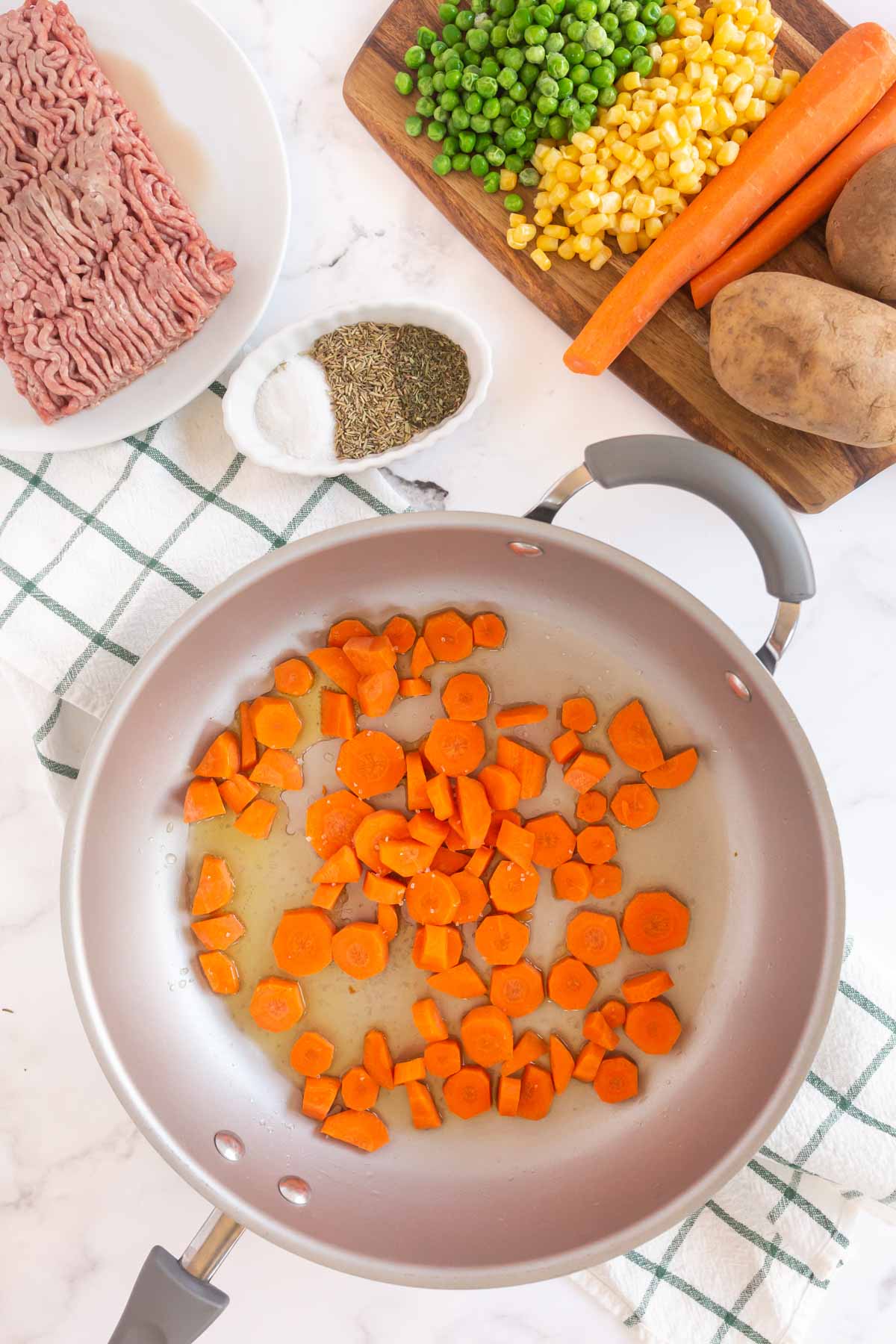 Metal pan with carrots cooking inside