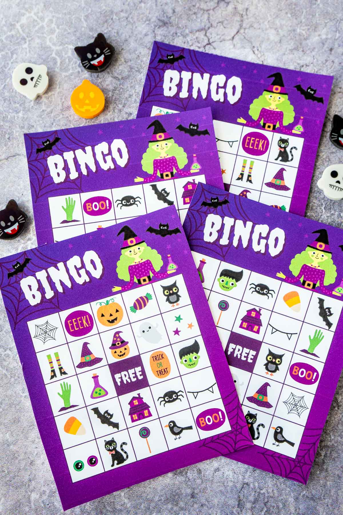 Four purple Halloween bingo cards with a witch on them