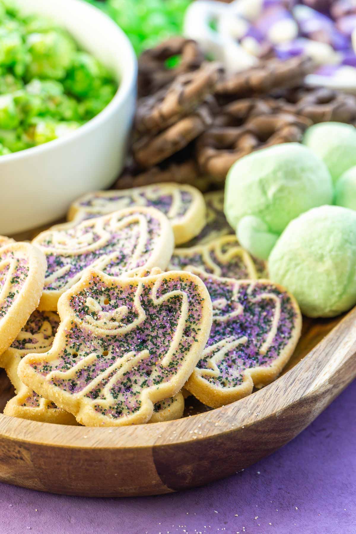 Purple cat cookies on a Halloween dessert board