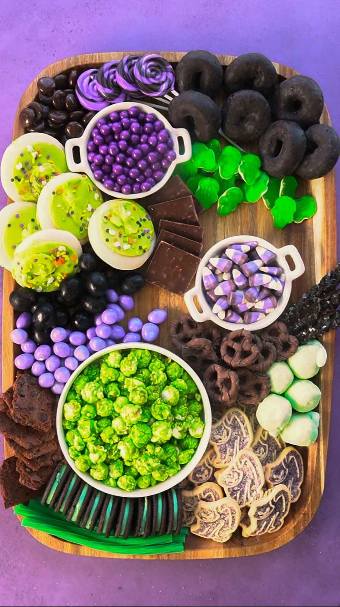 Halloween dessert board with lots of chocolate and gummy candies