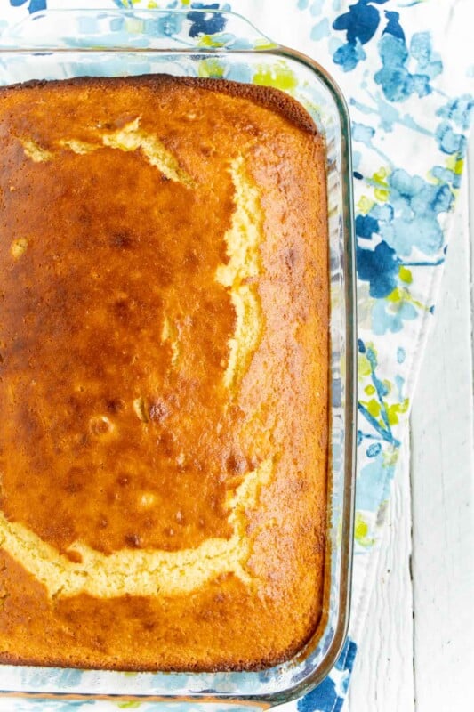 A glass pan with uncut honey cornbread