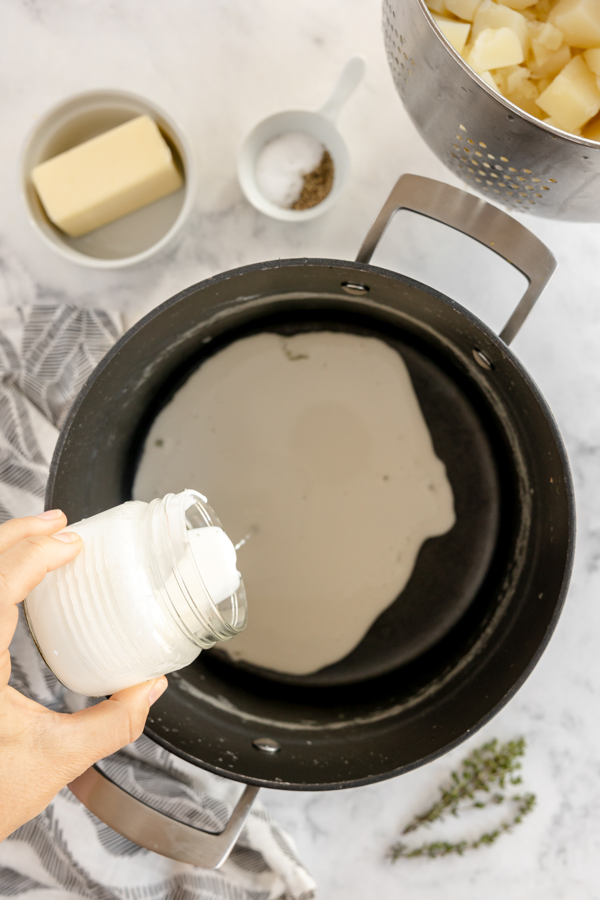 pouring cream into a pot