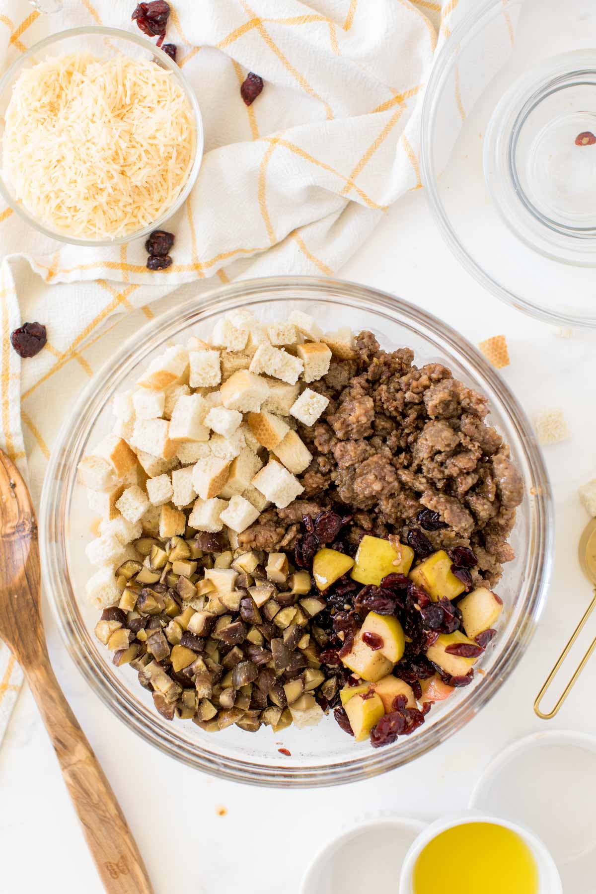 Bread, sausage, and apples in a large glass bowl