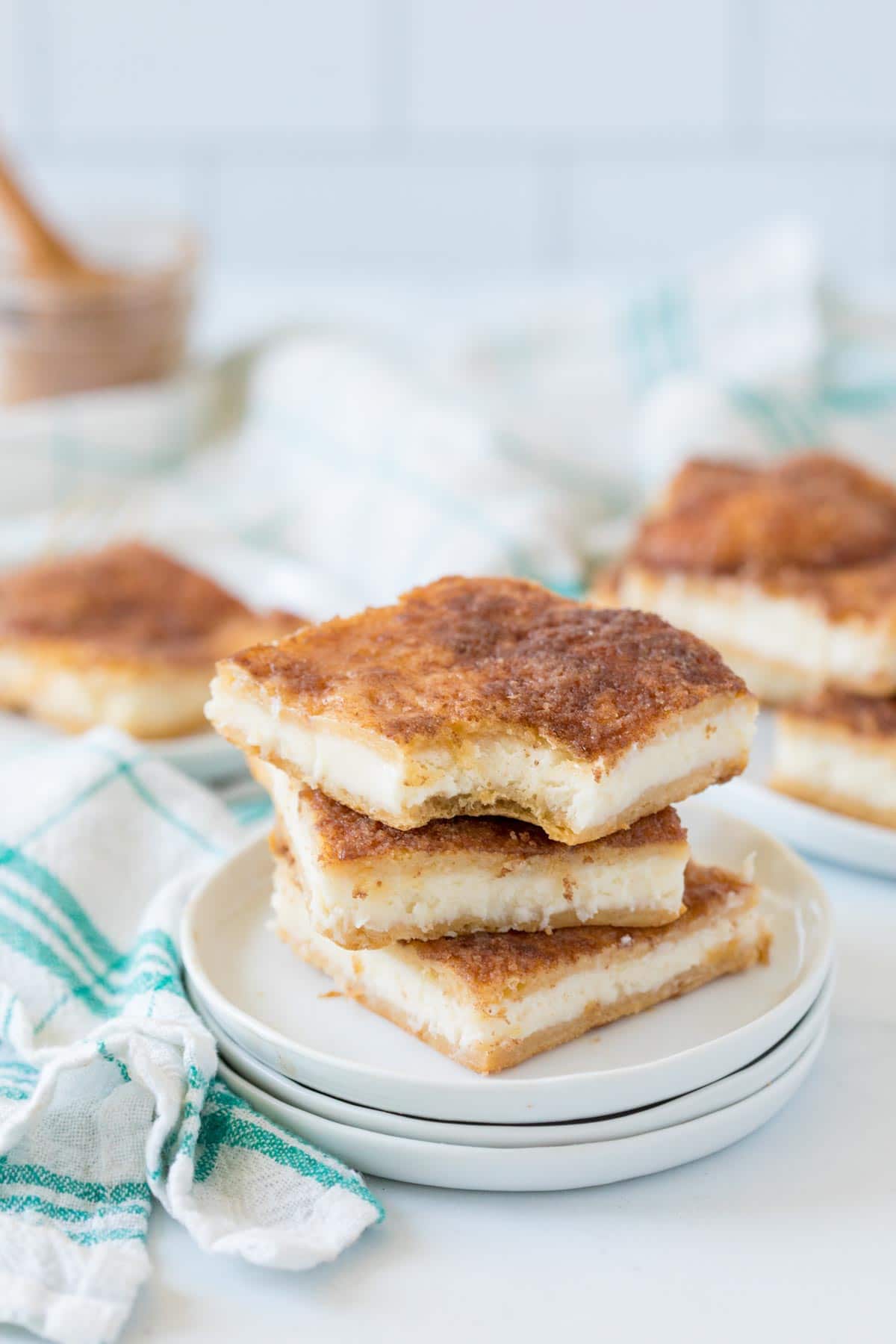 Three sopapilla cheesecake bars stacked on top of each other