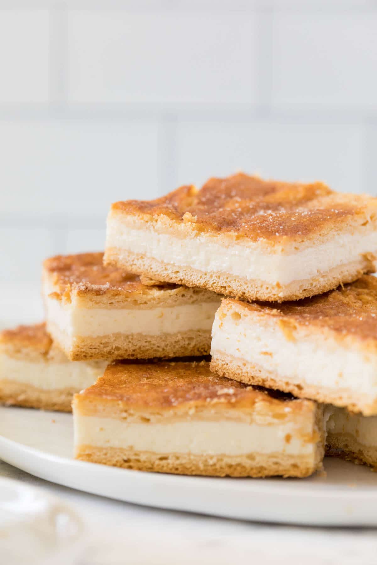 Sliced sopapilla cheesecake bars in a stack