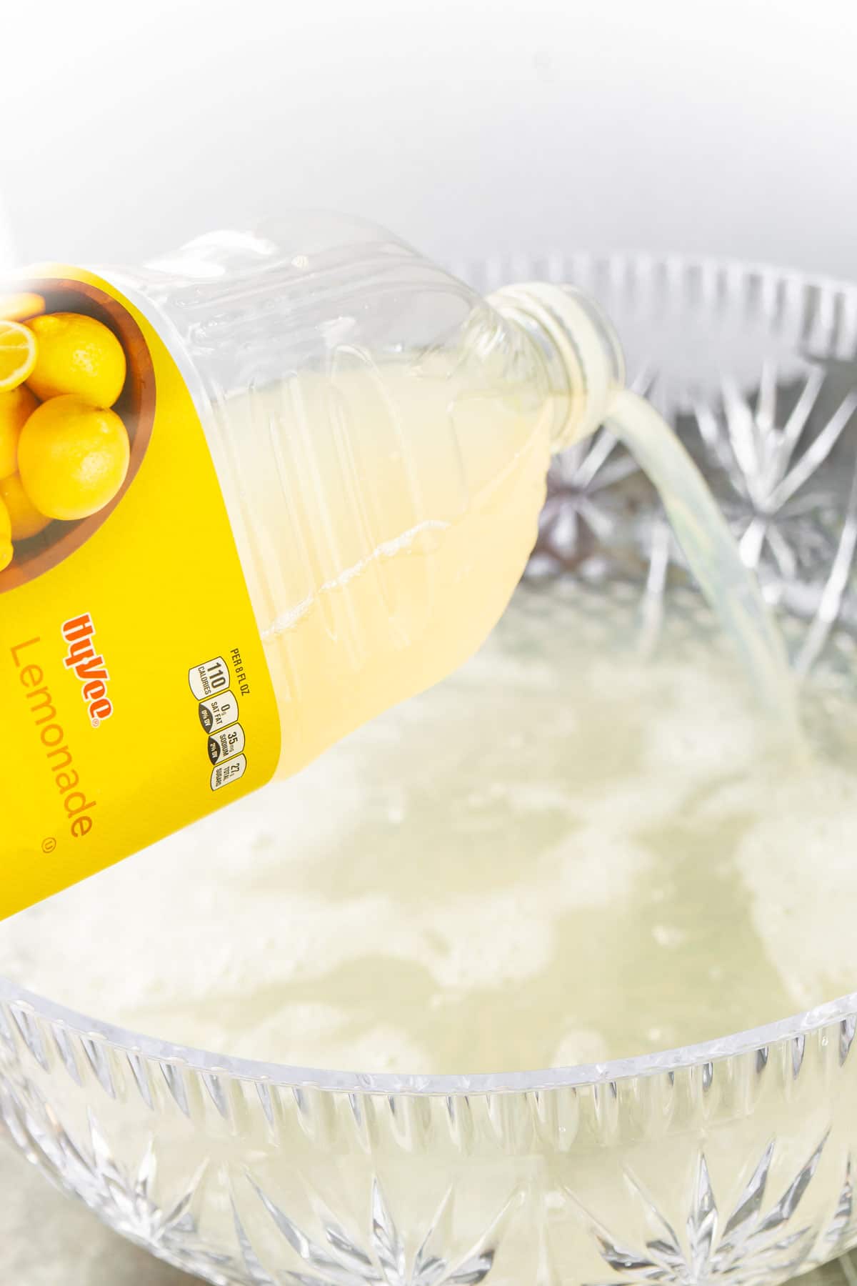 Lemonade being poured into a punch bowl