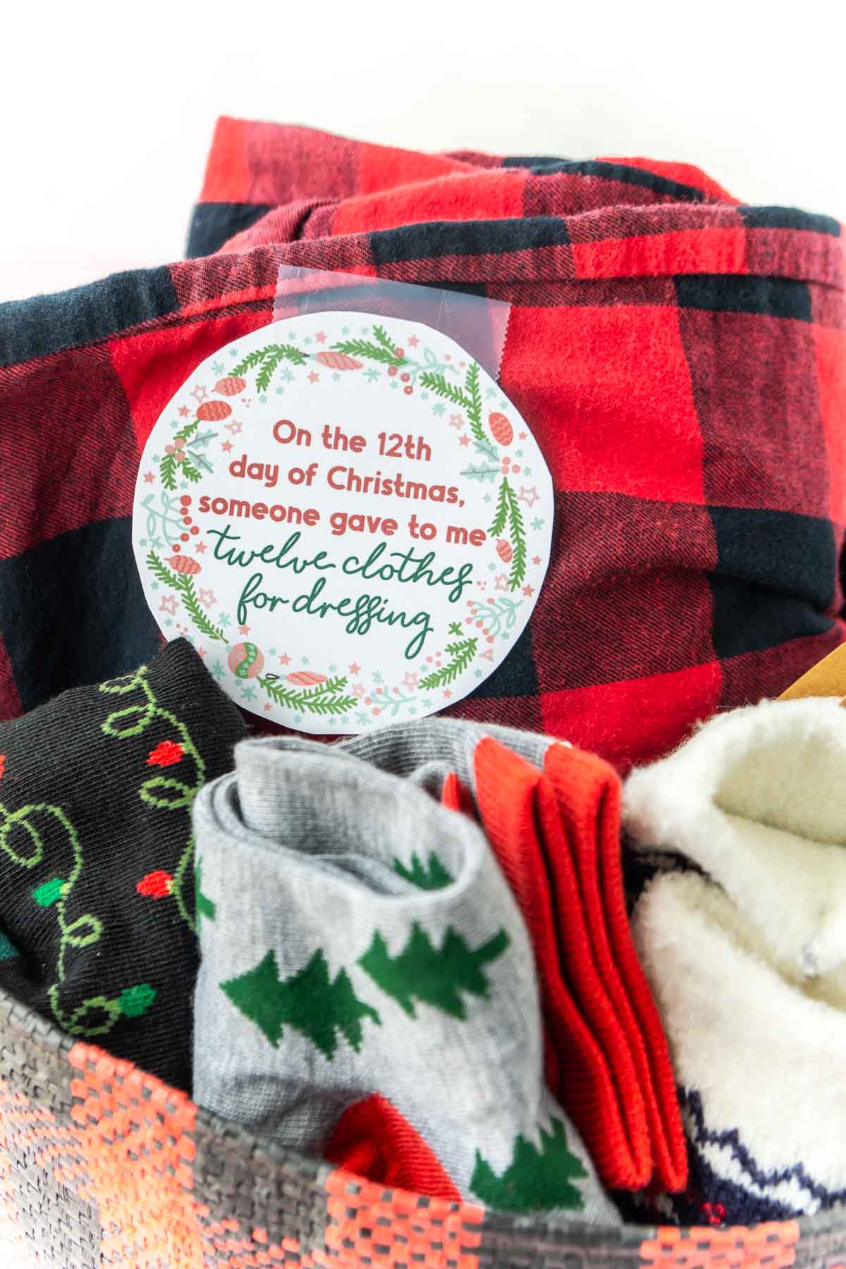 Clothes in a basket with a printed out 12 days of christmas tag