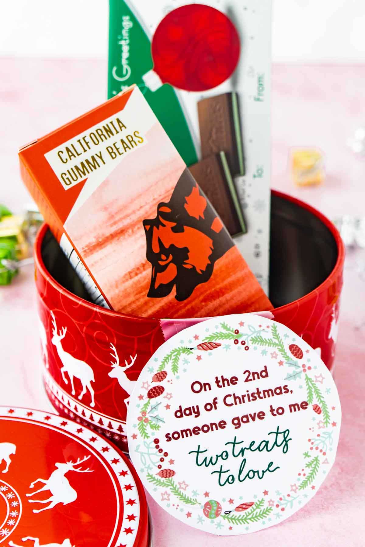 Tin with treats and 12 days of christmas tags taped on