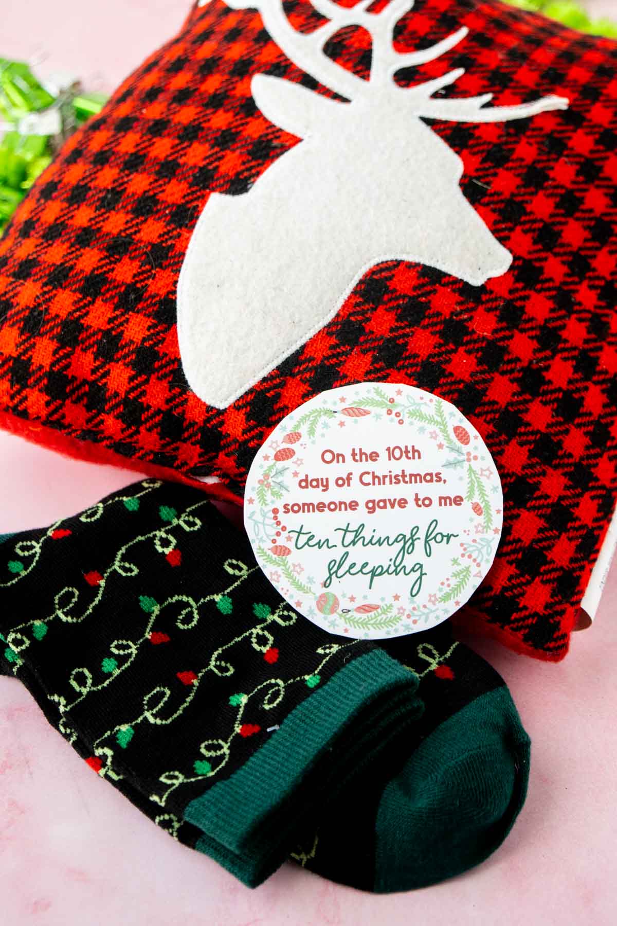 12 days of Christmas tag on top of a pillow and socks