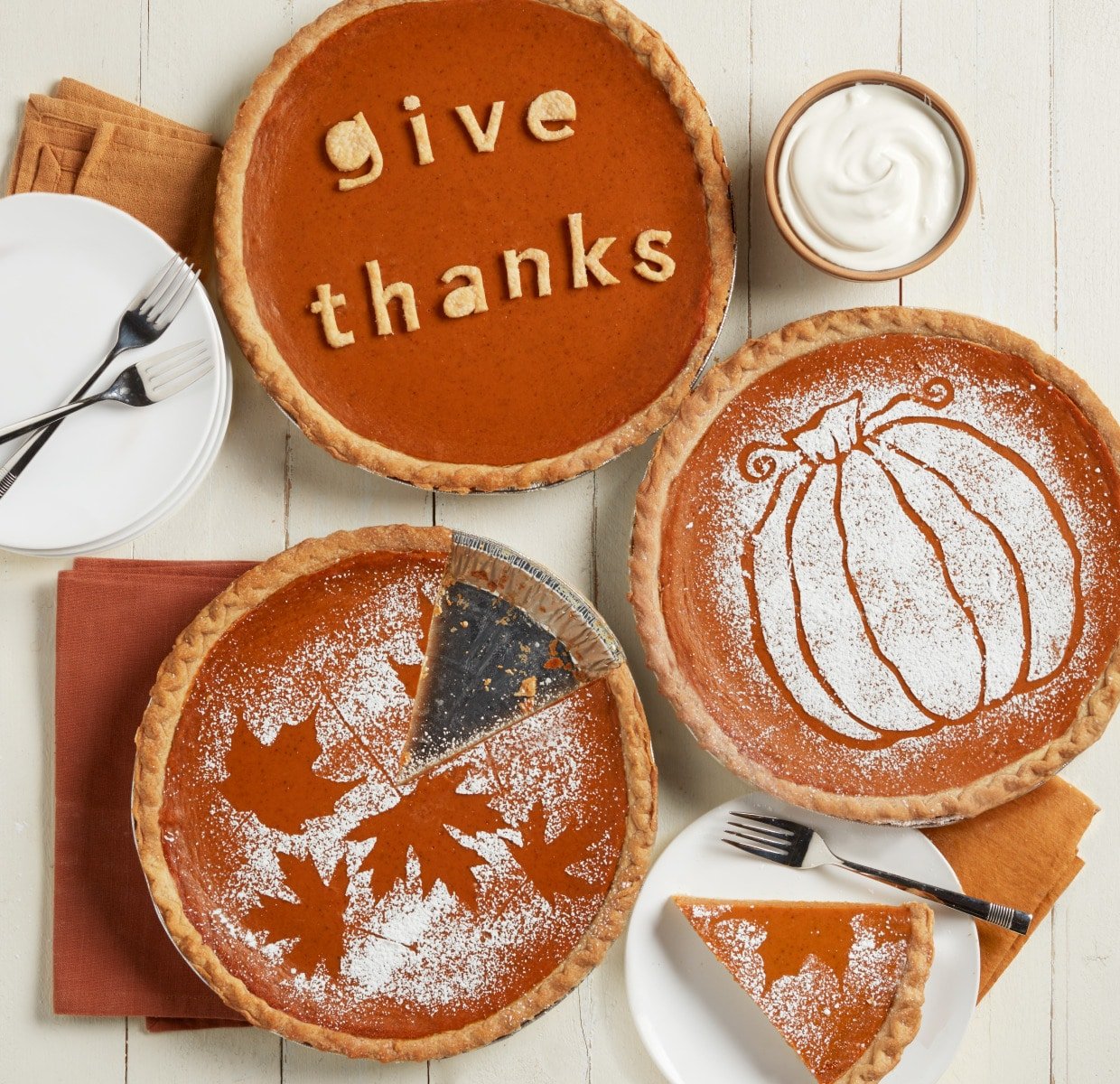 Three pumpkin pies with decorations on them