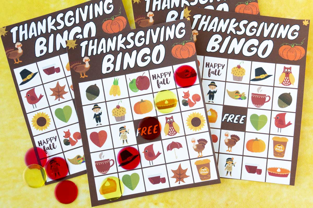 Three bingo cards with markers on them