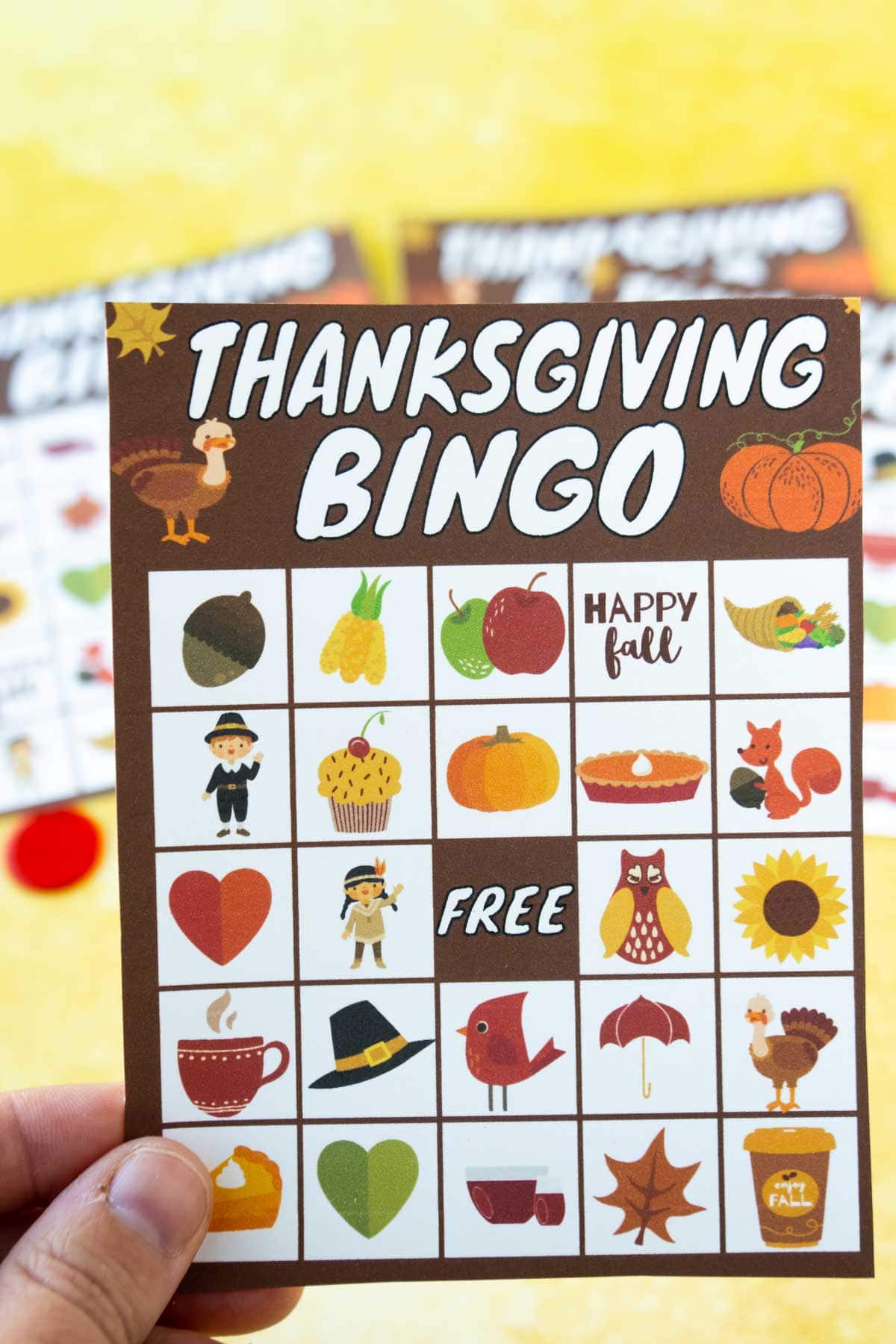 Woman's hand holding a Thanksgiving bingo card