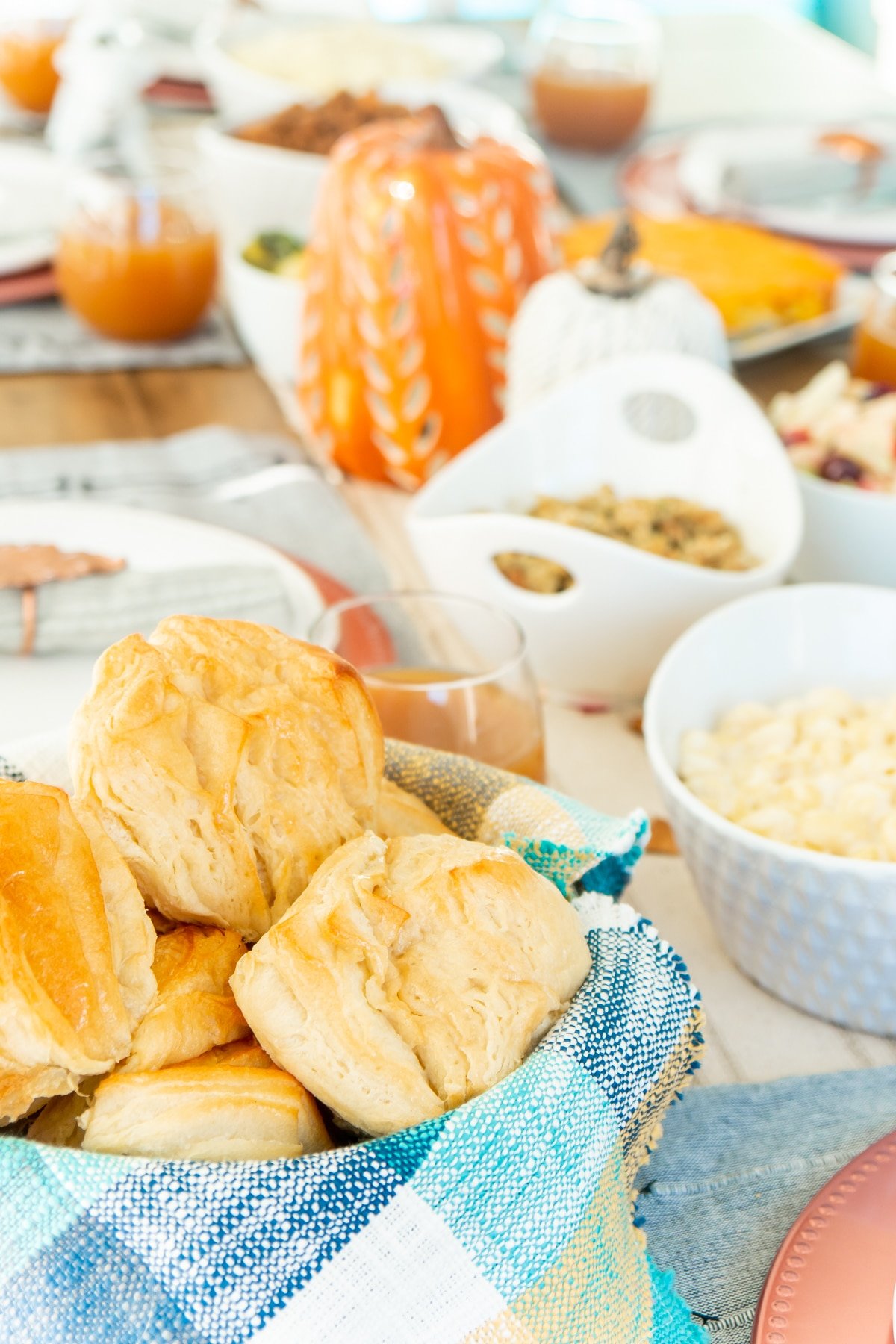 Bowl of rolls with a blue and green napkin