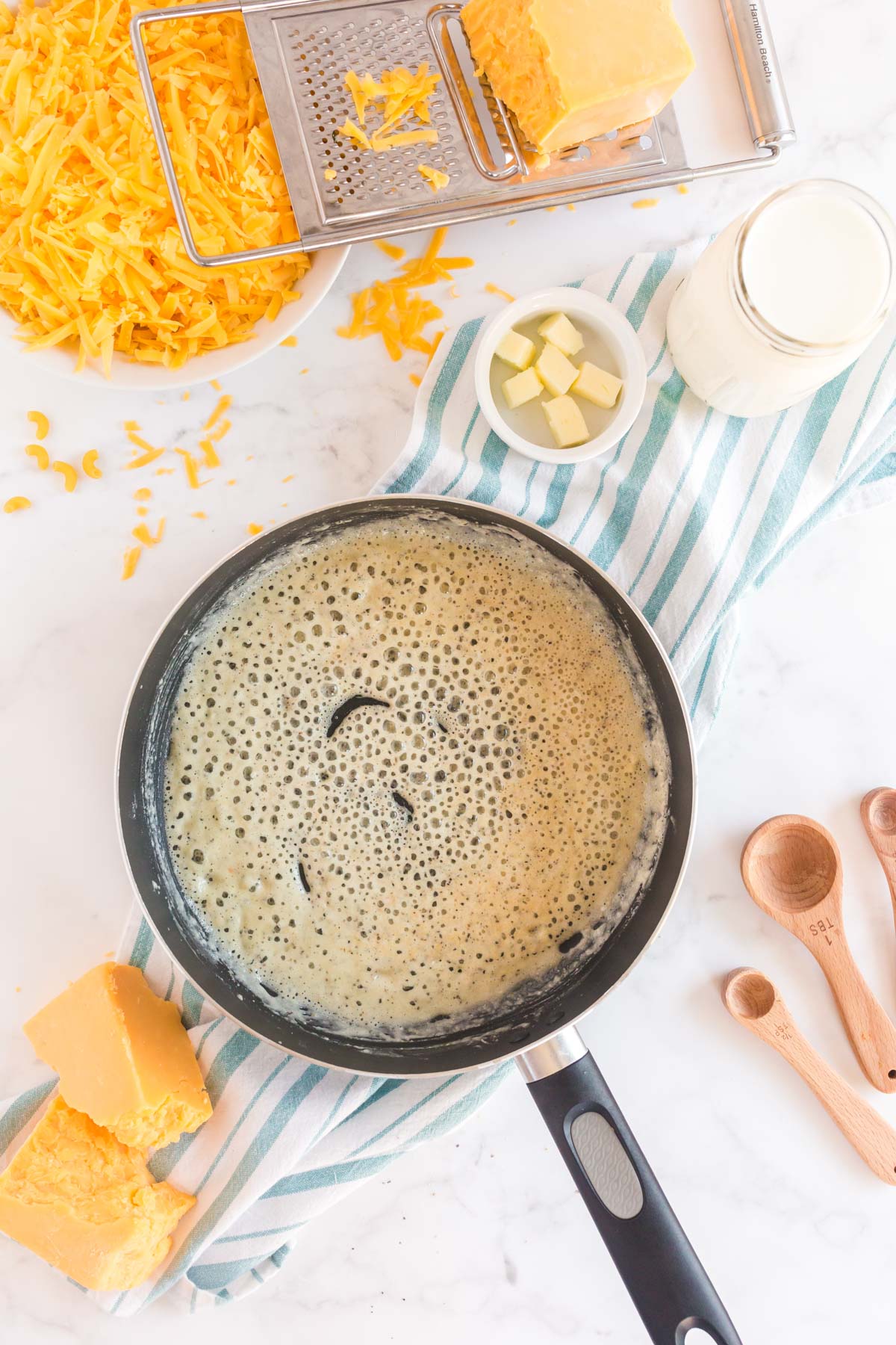 Melted butter in a pan with cheese around it