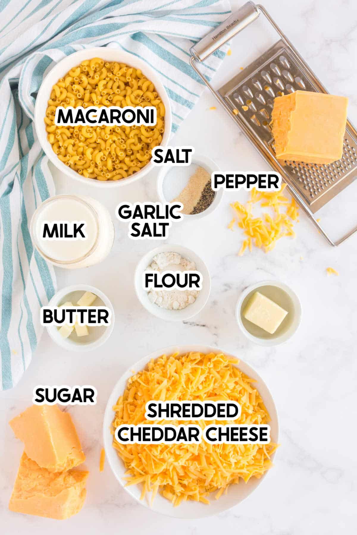 Ingredients for baked mac and cheese in bowls with labels