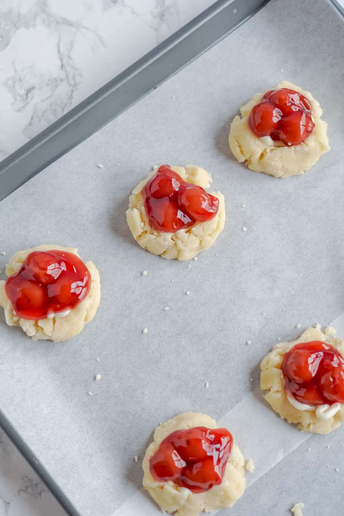 Sugar cookies with cherry pie filling on top