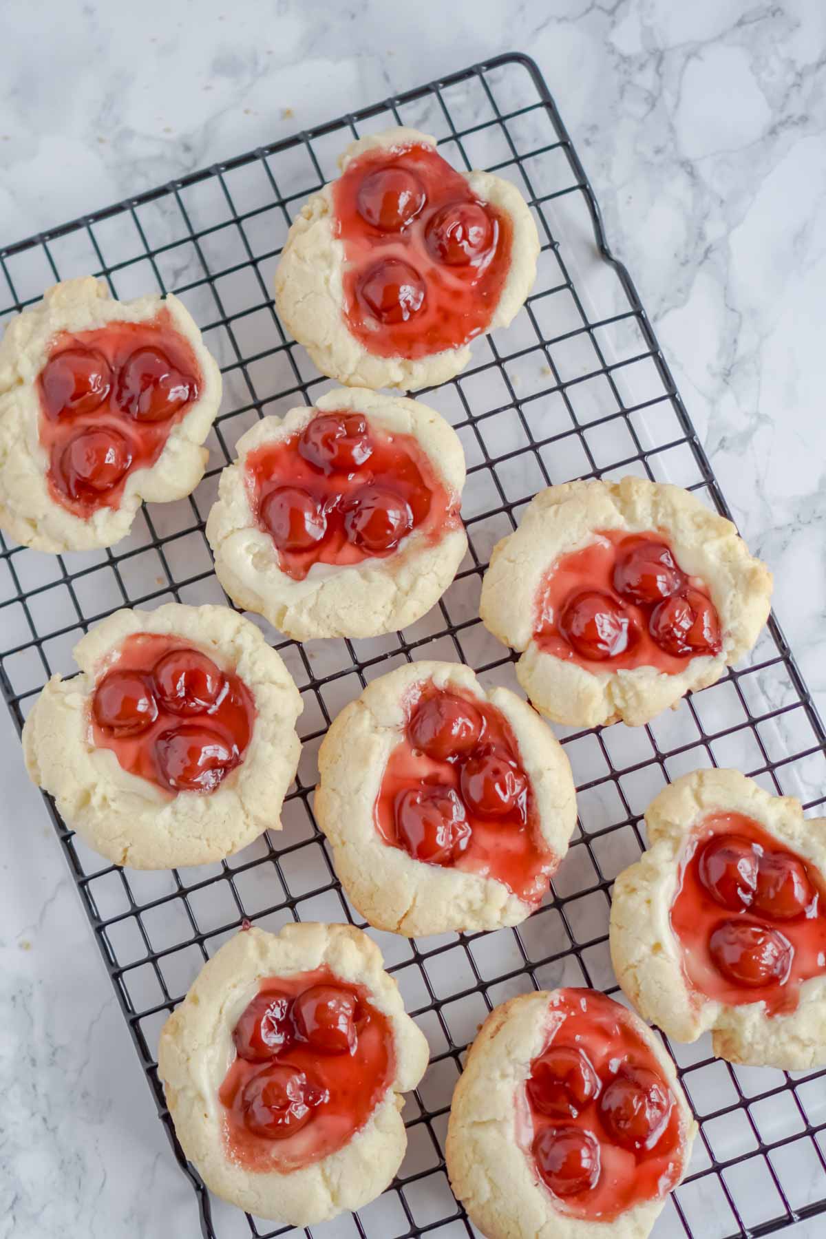 cherry cheesecake cookies on a cooling rack