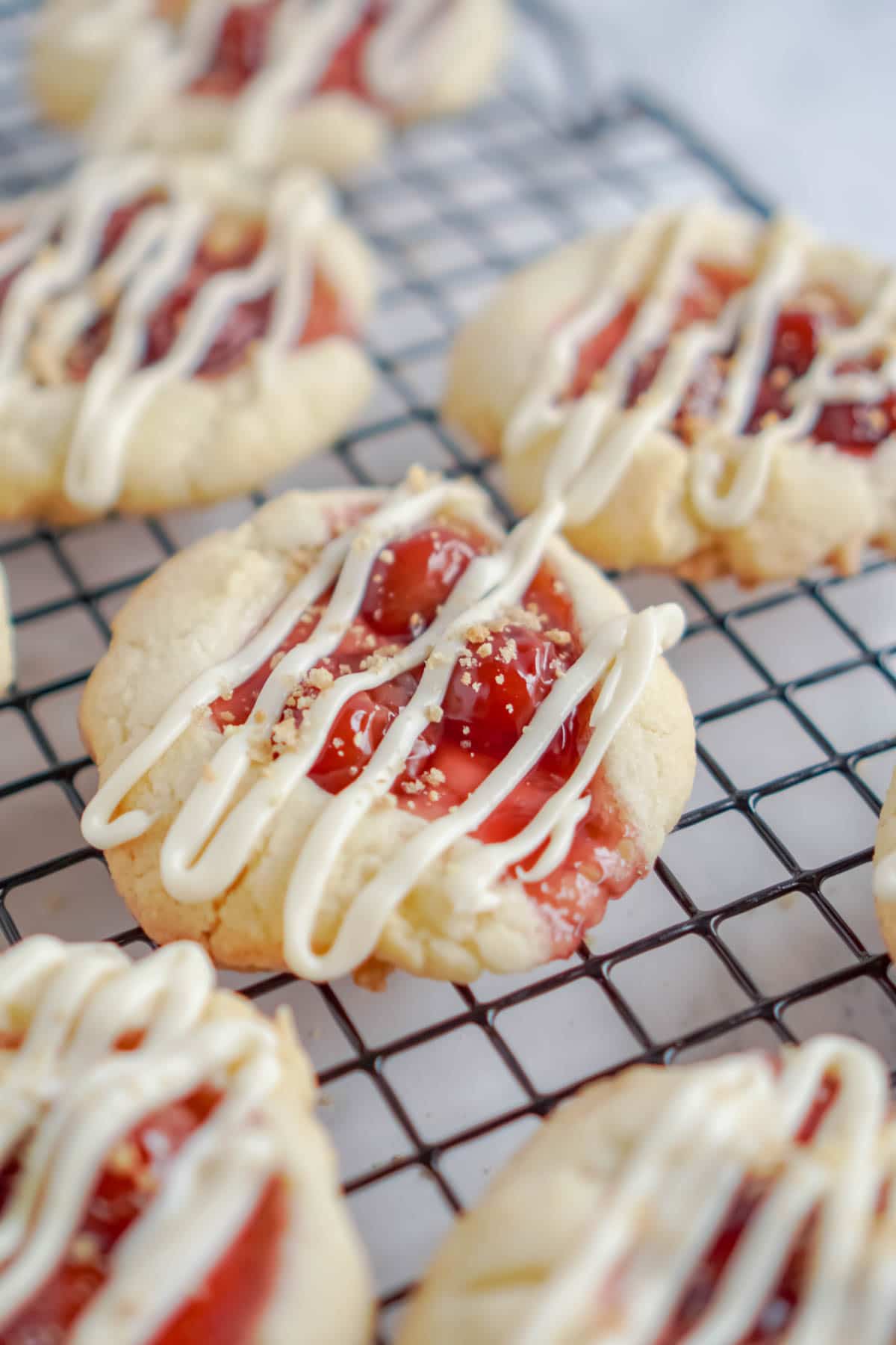 Cherry cheesecake cookies with cream cheese drizzled on top