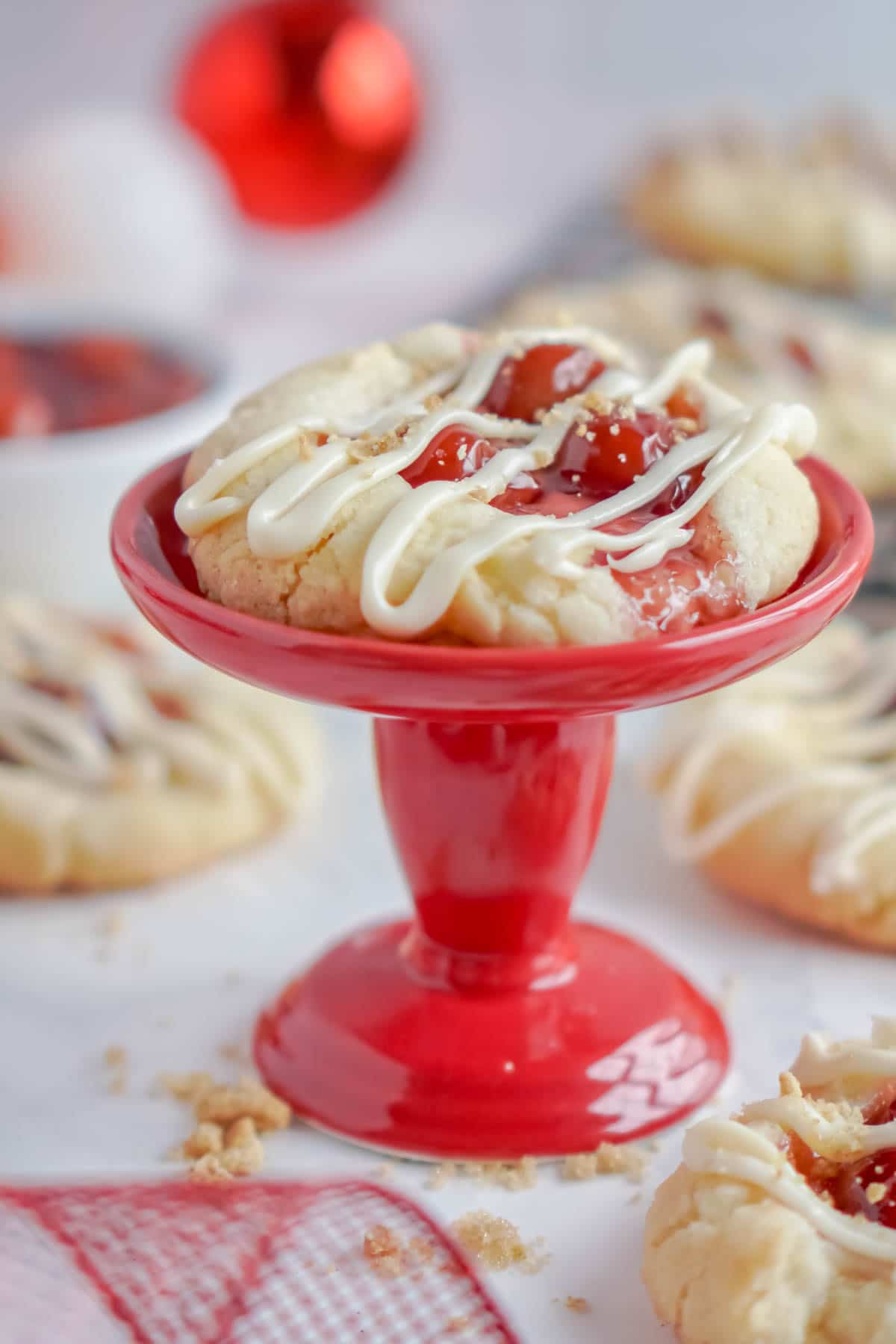 Cherry cheesecake cookies on a red cookie stand