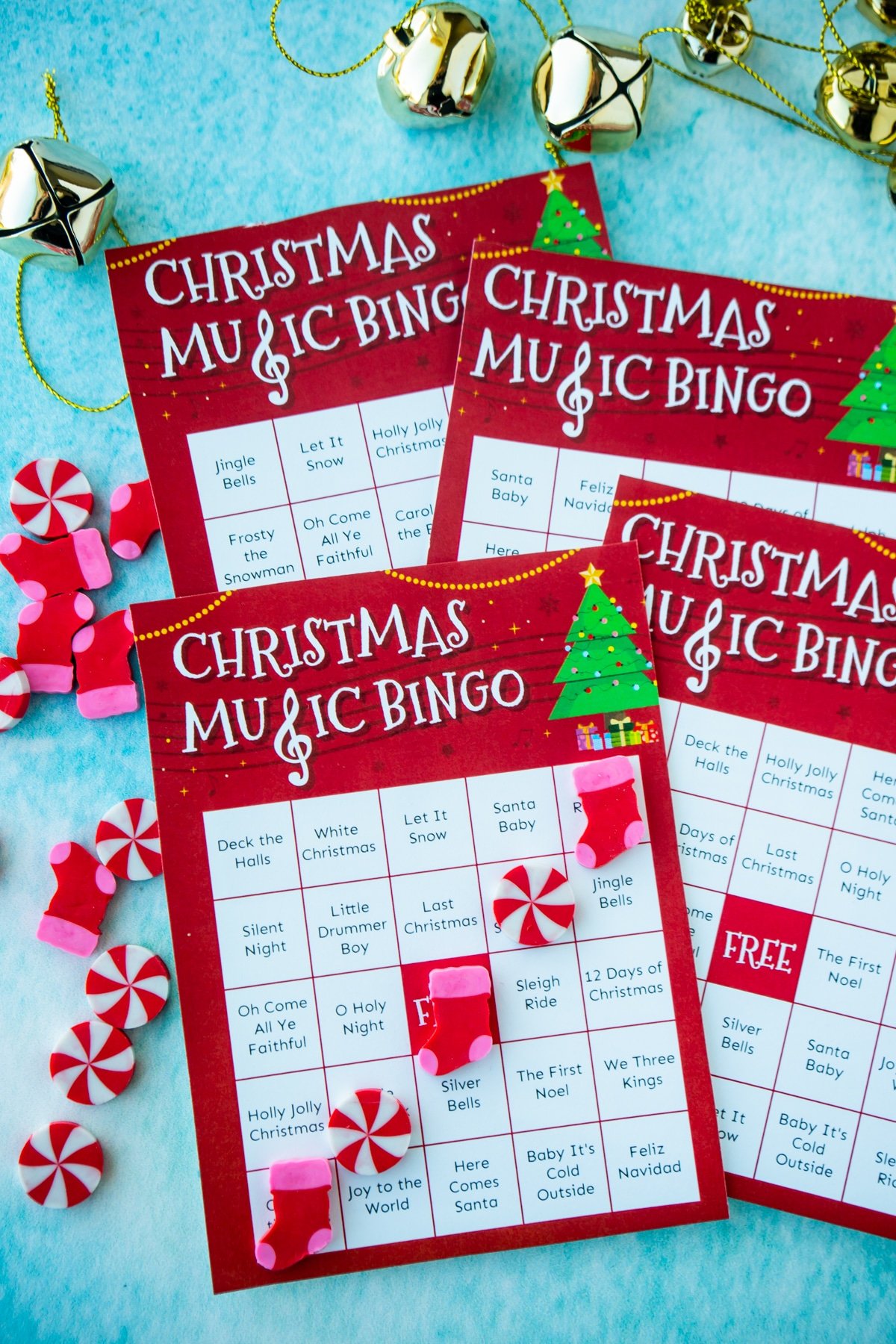 Four Christmas music bingo cards on a blue background