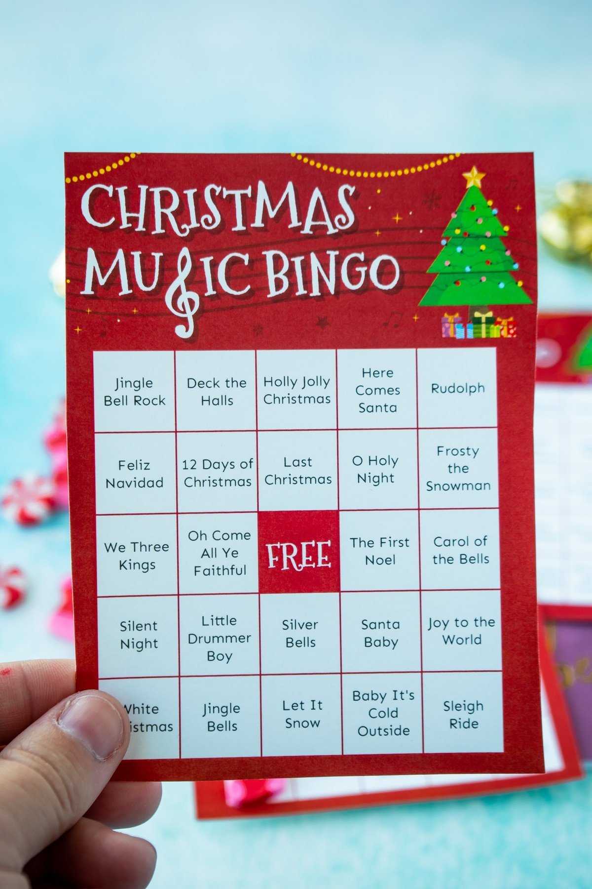 Hand holding a Christmas music bingo card