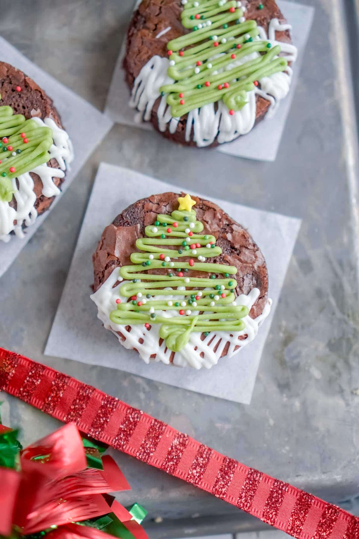 Christmas tree brownies on a piece of parchment paper