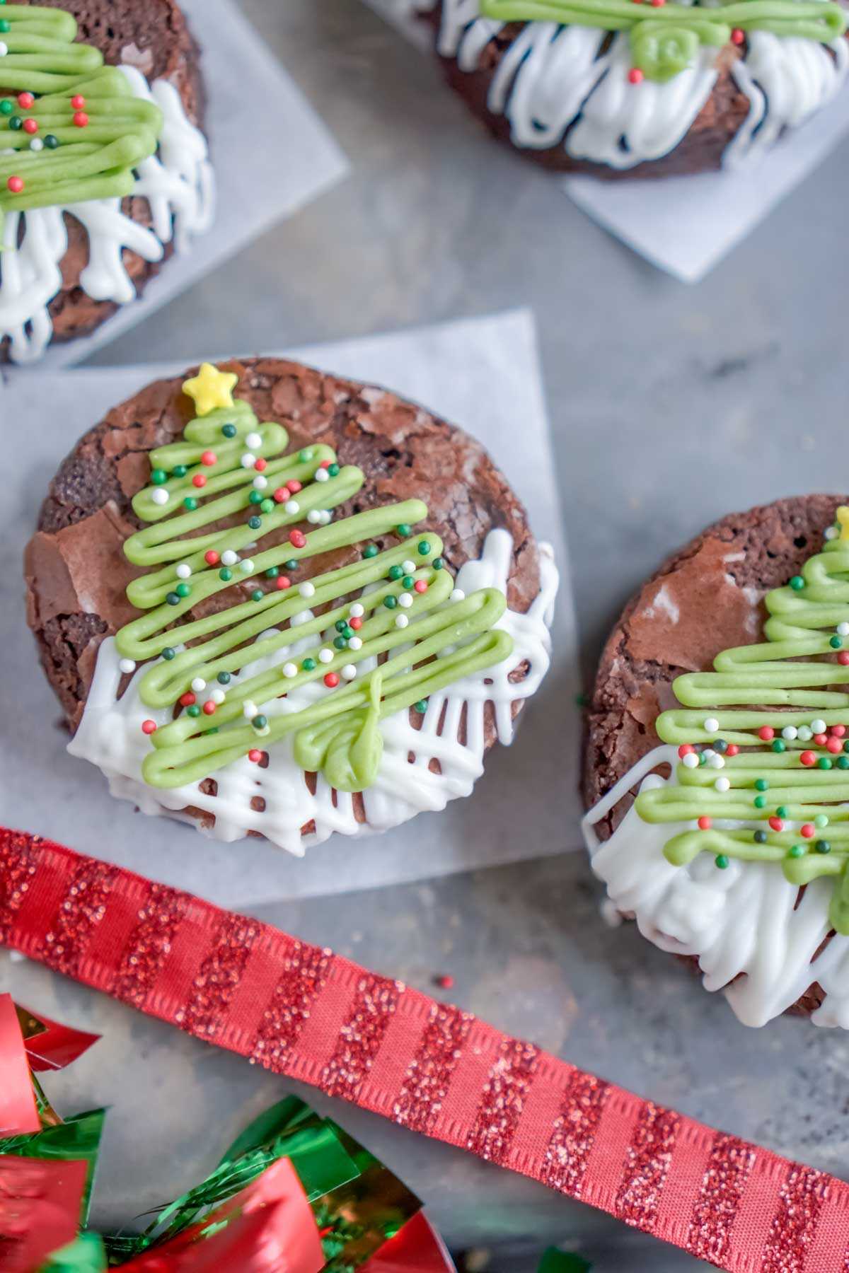 A set of Christmas tree brownies on parchment paper