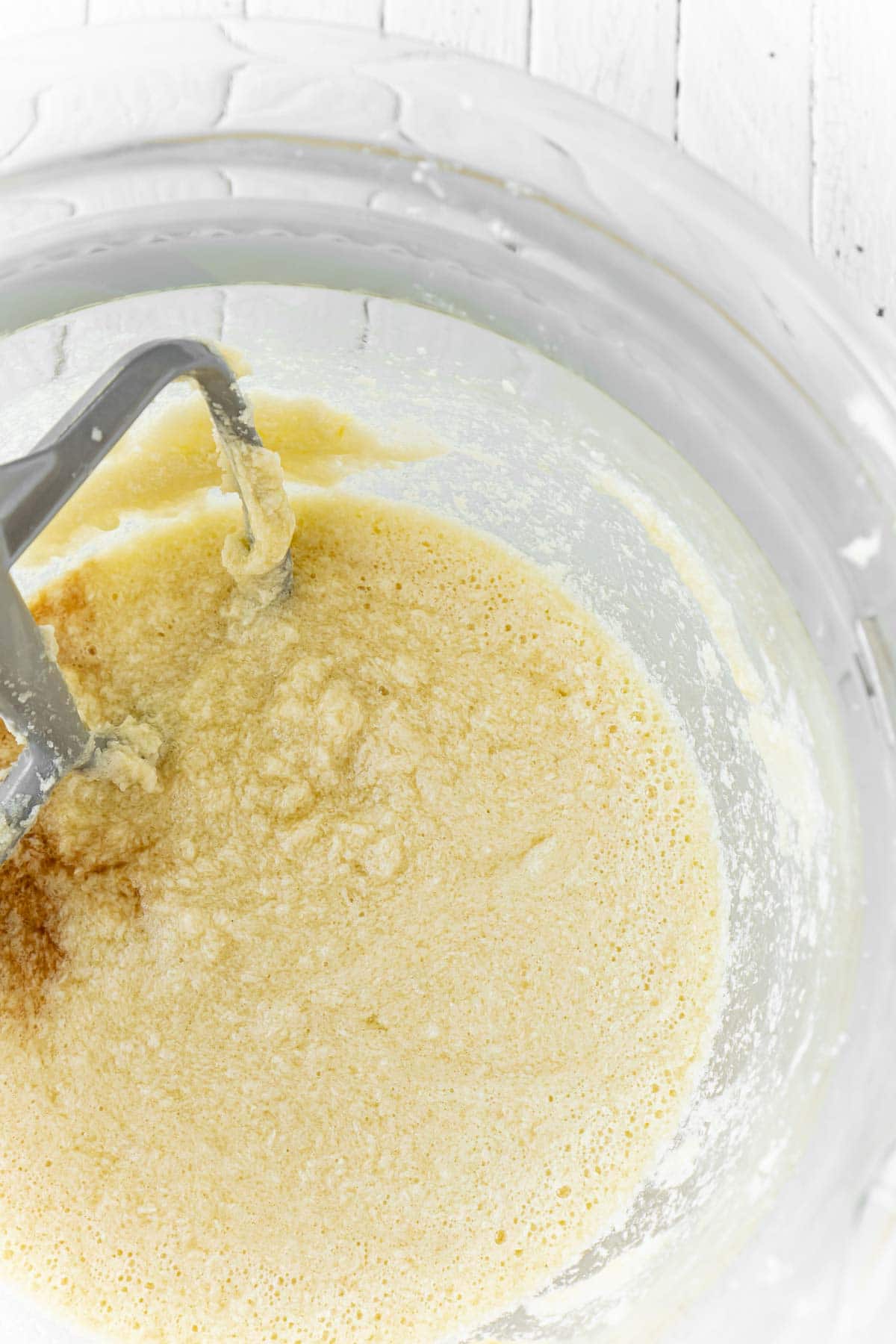 orange sugar cookie dough in a mixing bowl