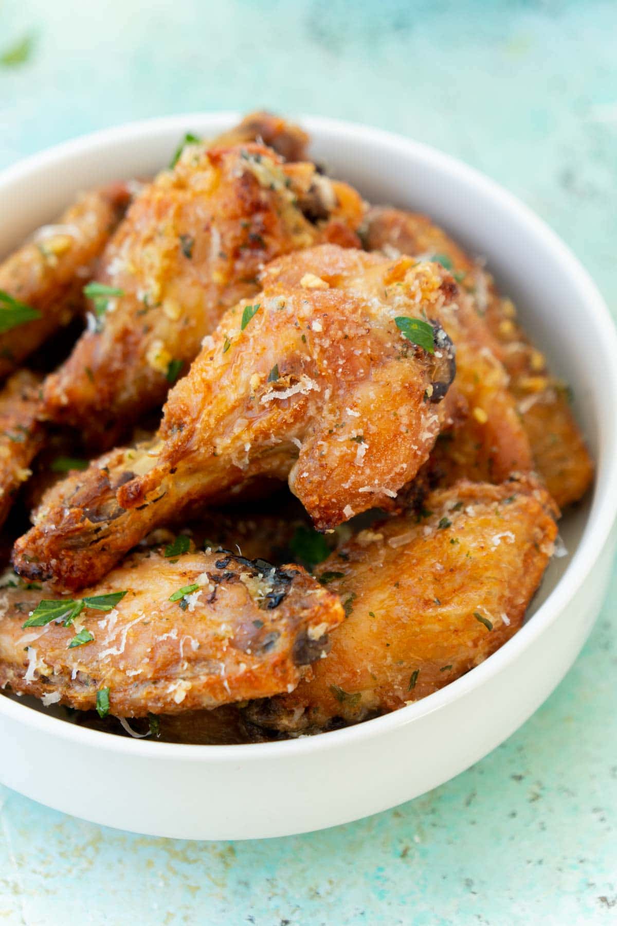 White bowl with garlic parmesan wings