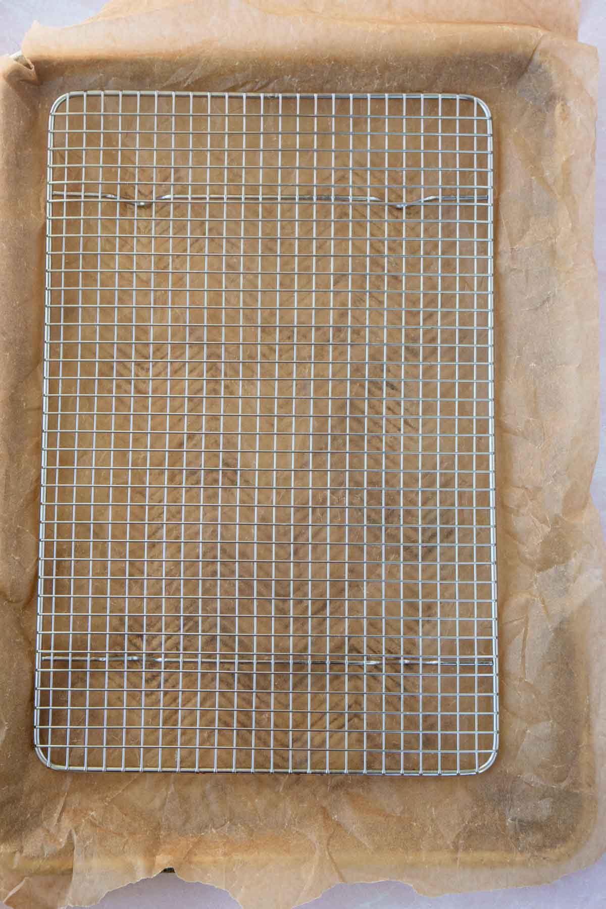 Metal rack on top of parchment paper on a baking sheet