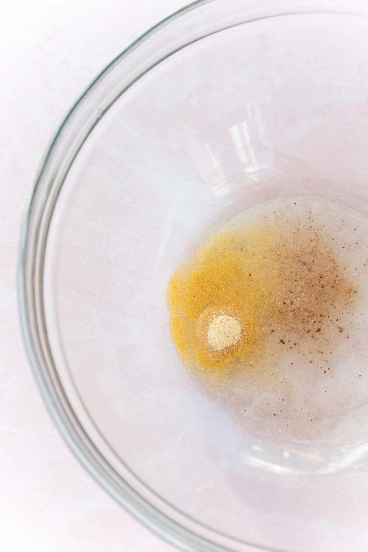 Oil and spices in a large glass bowl