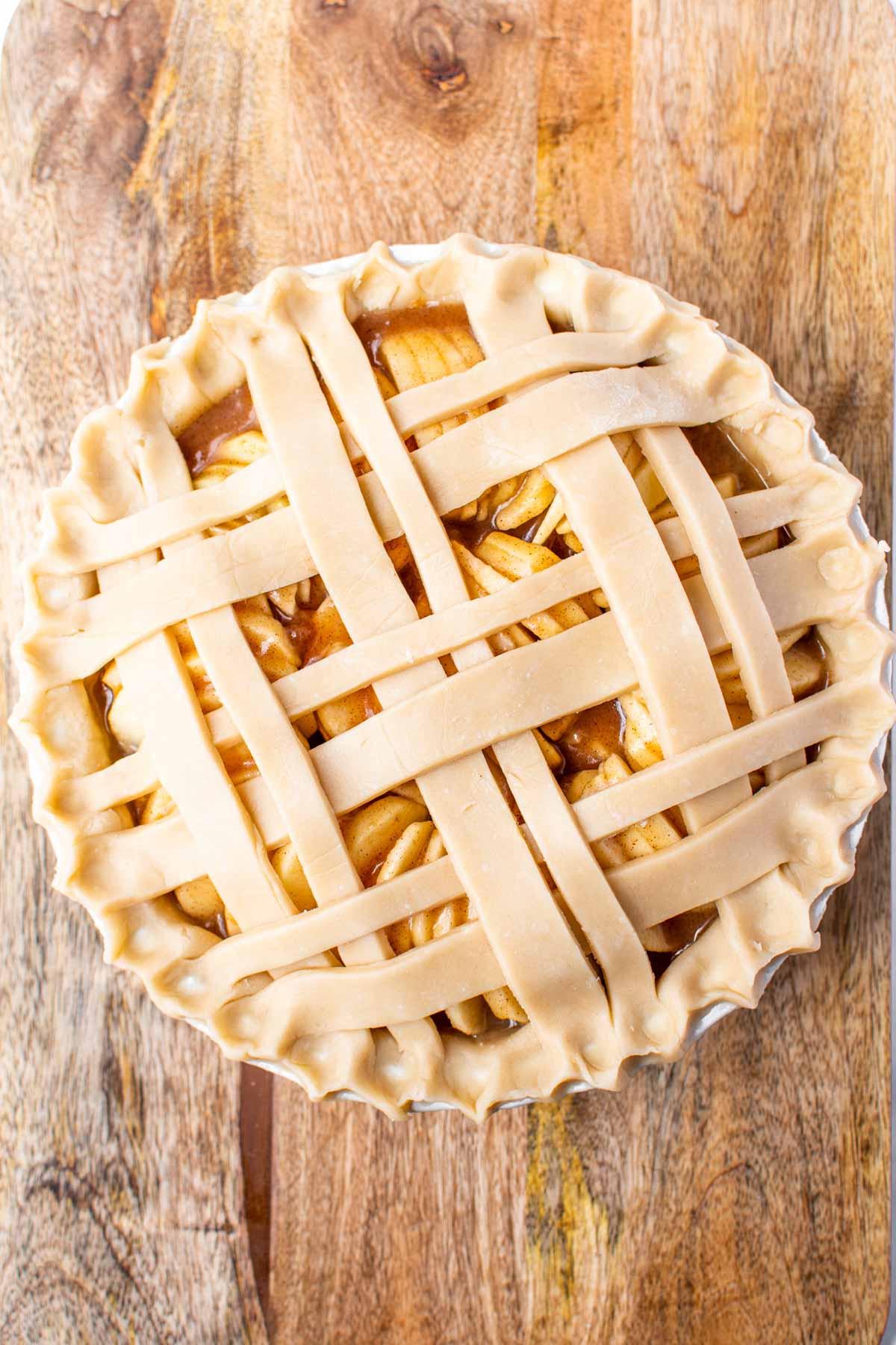 Homemade apple pie topped with strips of pie crust