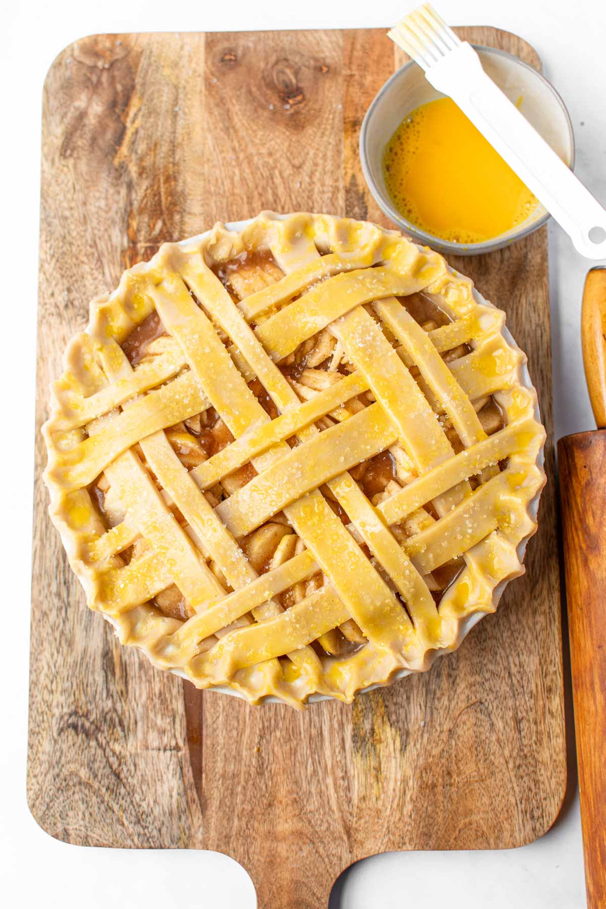Homemade apple pie topped with strips of pie crust