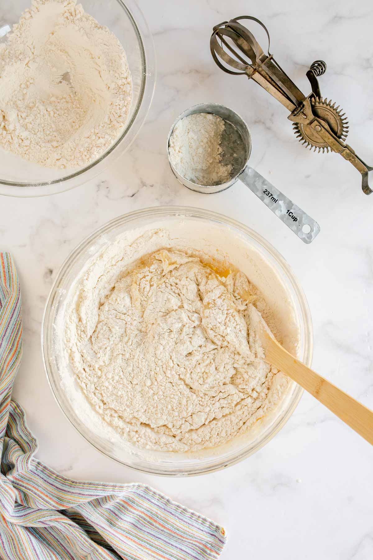 Flour in a bowl with a wooden spoon