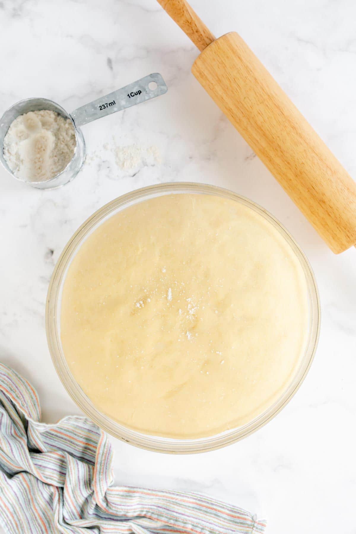 Dough for homemade crescent rolls in a glass bowl