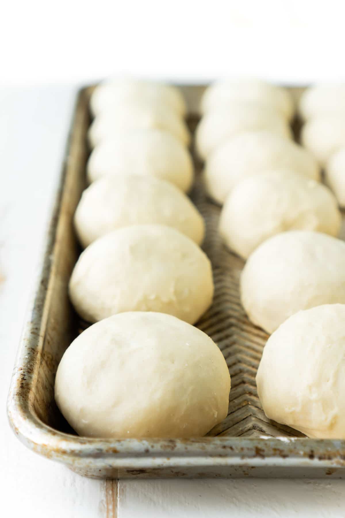 Baking sheet full of homemade yeast rolls ready to be baked