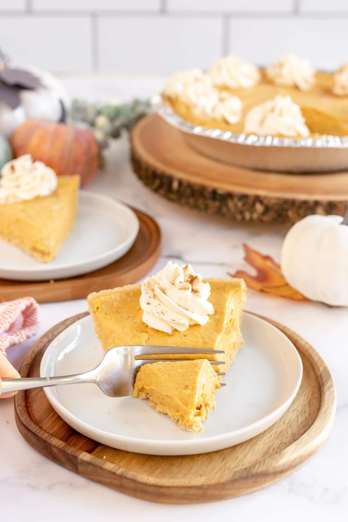 Fork cutting a bite out of a slice of no bake pumpkin pie