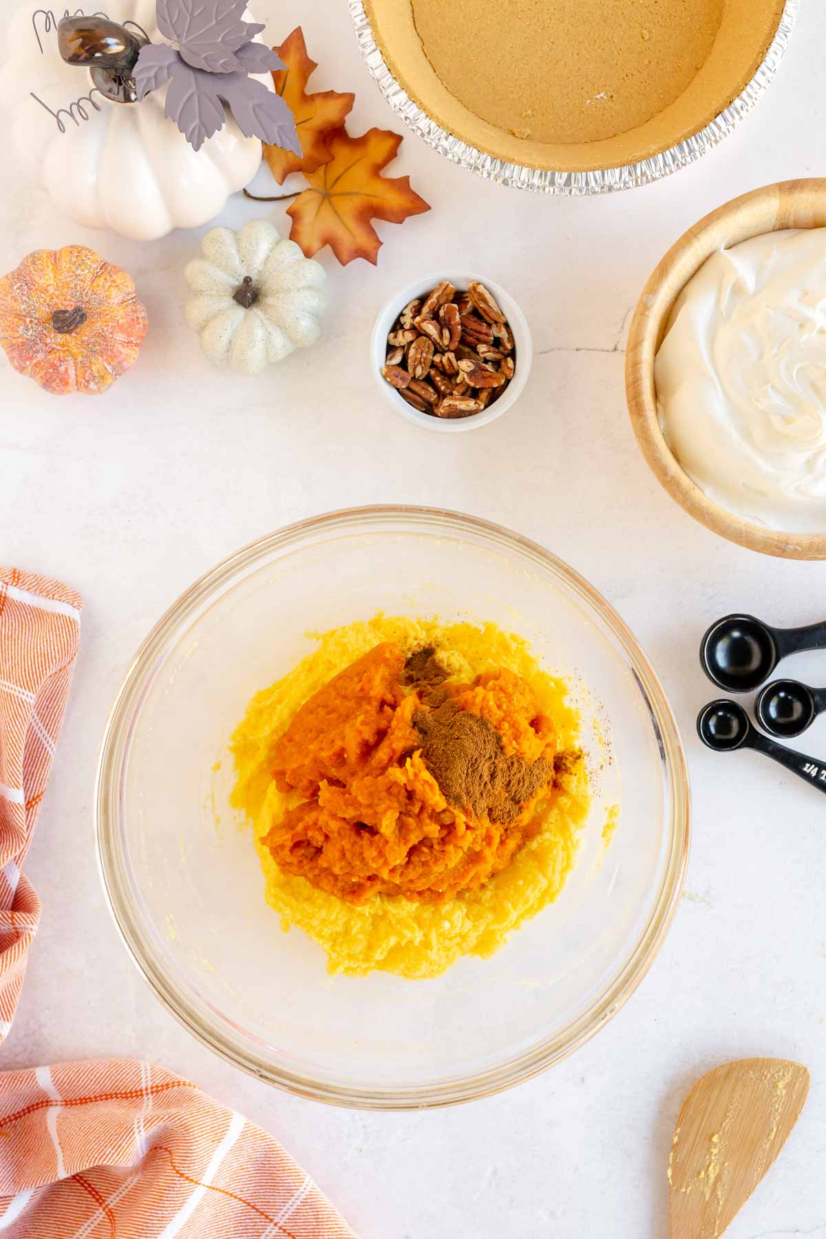 Glass bowl with pie filling, pumpkin, and pumpkin pie spice