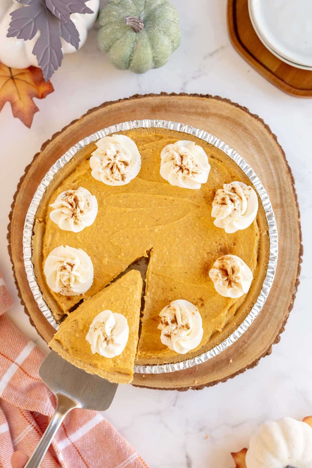 No bake pumpkin pie topped with whipped cream and cinnamon