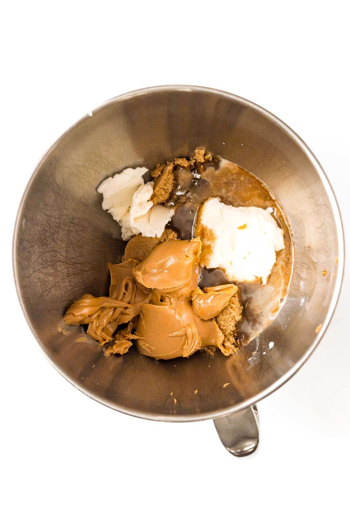 Ingredients for peanut butter blossoms in a mixing bowl